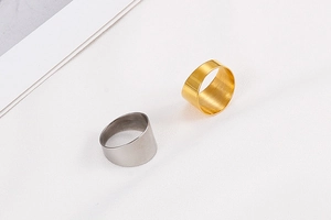 Detailed view of wide titanium steel rings featuring a premium brushed metal texture