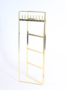 Detailed view of golden multi-layer metal jewelry display stand with hooks for necklaces