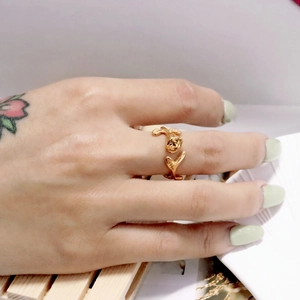 Detailansicht eines Rosenknospenrings mit Blattdesign in Gold am Finger
