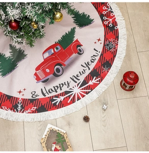 Detailed view of burlap Christmas tree skirt with red truck pattern and white tassels
