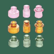 Detailed grid view of ribbed glass candle holders in pink, yellow, and green hues