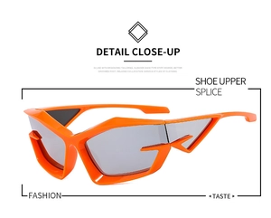 Macro detail of futuristic bright orange geometric sunglasses with segmented wing-like frames