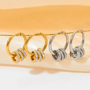 Gold and silver stainless steel hoop earrings with sparkling crystal-encrusted charms