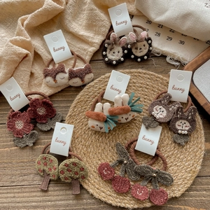 Detailed embroidered animal hair ties featuring cartoon rabbits and foxes on display