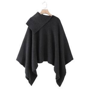 Minimalist dark grey knitted poncho coat with asymmetrical high neck design on white background