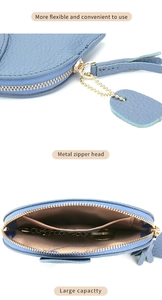 Detailed view of blue leather coin purse featuring lychee texture and gold metal zipper