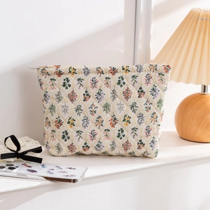 Detailed close-up of quilted floral cosmetic bag with diamond stitching and zipper