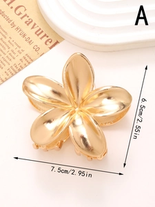 Detail shot of golden metal flower hair claw clip with dimensions 7.5cm by 6.5cm