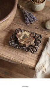 Detailed view of vintage hollowed cast iron soap dish with natural handmade soap