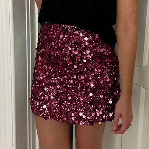 Macro detail of wine red sequin fabric texture on this elegant mini bodycon skirt