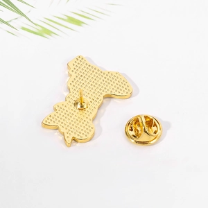 Close-up of the metal pin back and gold clutch for the cartoon cat enamel badge