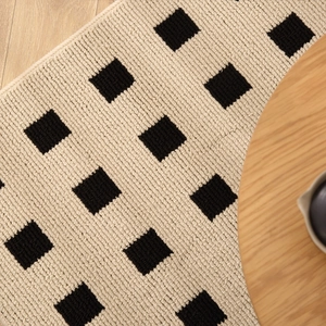 New Chinese style woven entryway mat with black grid pattern on light wood floor
