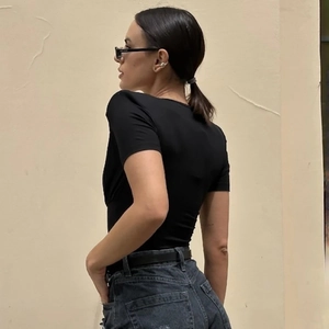 Slim fit black short sleeve bodysuit with V-neck showing back view and high waist jeans
