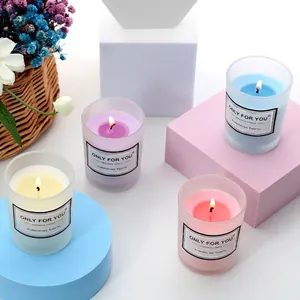 Set of four handmade soy wax aromatherapy candles in colorful frosted glass jars