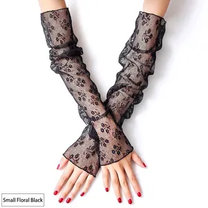 Macro detail of black mesh lace arm sleeves with floral embroidery and fingerless design