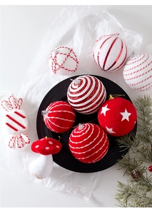 Macro shot of red and white Christmas tree ornaments including candy and striped balls