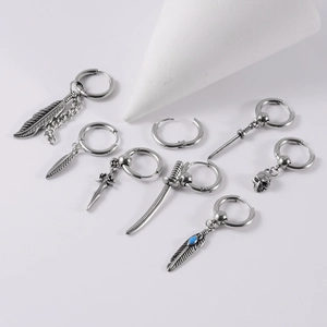 Detailed macro view of assorted stainless steel hoop earrings with unique gothic pendants