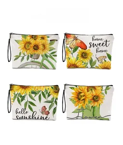 Detail showing four sunflower printed makeup bags with black zippers and wrist straps