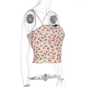 Detail of floral camisole showing red cherry prints, black bow, and lace trim details