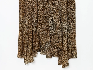 Close-up of leopard print chiffon dress featuring layered ruffle hem and fluid fabric texture
