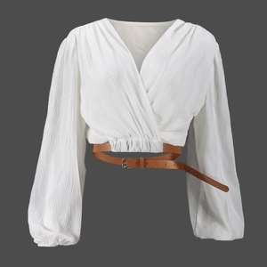 Detail of white pleated long sleeve cardigan with a brown adjustable belt and V-neckline