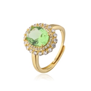 Macro detail of 18K gold plated ring featuring green zircon stone and crystal pavé