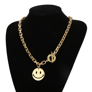Golden OT clasp chain necklace with smiley face pendant on a black mannequin