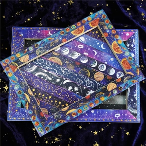 Detailed close-up of galaxy themed washi tape with starry planet gold foil patterns