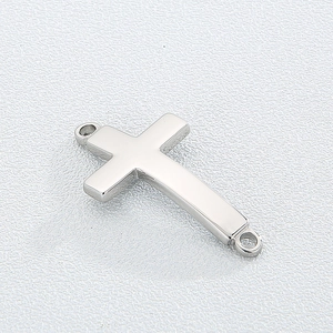 Macro view of polished silver titanium steel cross pendant with dual connection rings