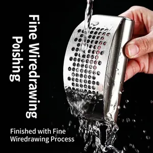 Polished stainless steel rocker garlic press with easy-to-clean water rinse feature