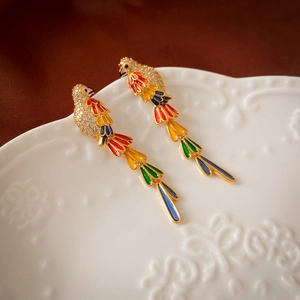 Detail of colorful parrot drop earrings with tassels and micro-set cubic zirconia