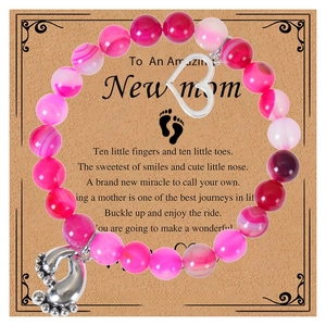 Close-up of 8mm pink zebra stone beads with heart and baby feet charms for new moms