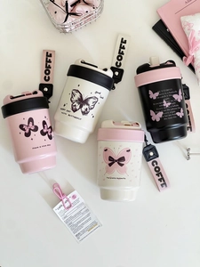 Detail view of four butterfly patterned coffee mugs with colorful lids and carry straps
