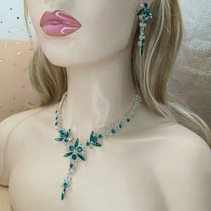 Close-up of bridal jewelry set with green crystal teardrop necklace and earrings