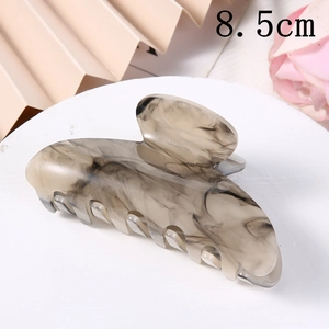 Detail view of 8.5cm acetate hair claw clip with elegant black marble pattern and texture