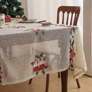 Detailed lace embroidery with Christmas socks and candy canes on festive table cloth