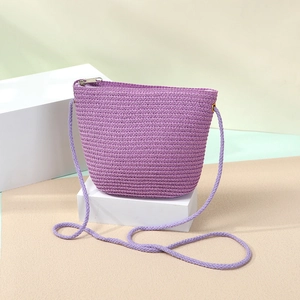 Detailed texture of purple handwoven shell bag with sturdy rope shoulder strap and zipper