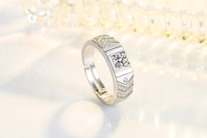 Macro side view of silver male wedding ring with round diamond and adjustable open band
