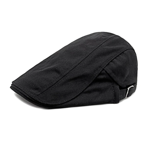 Detailed close-up of a black cotton newsboy cap featuring an adjustable metal side buckle