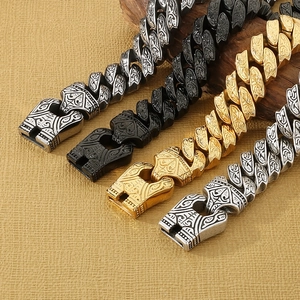Macro detail of men's stainless steel curb chains with vintage etched patterns in three colors