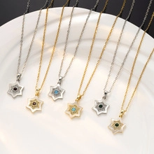 Detail view of hexagram necklaces in gold and silver with colorful stone pendants