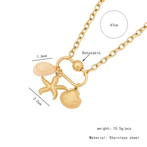 Detail view of gold stainless steel necklace with shell, starfish and rotatable pendants