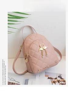 Close-up of pink quilted mini backpack featuring gold swan charm and crystal drops