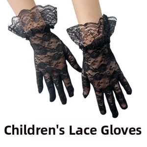 Close-up of black lace children's performance gloves with floral patterns and ruffled cuffs