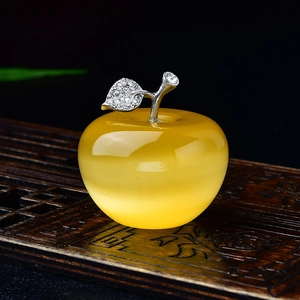 Close-up of a yellow crystal apple with silver metal leaf and sparkling rhinestones