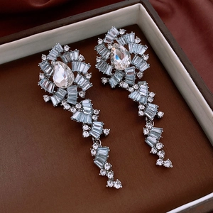 Detail of luxury teardrop fringe earrings with blue and clear marquise zircons