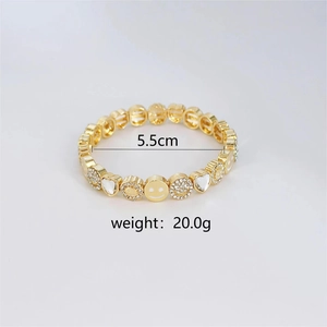 Detail view of gold smiley face bracelet showing 5.5cm inner diameter and 20g weight