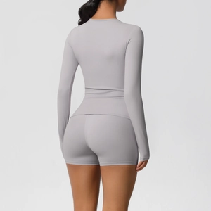 Detail view of the back fit of a light purple long-sleeve yoga set with high waist shorts