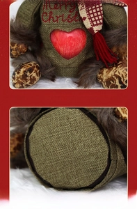 Detail view of burlap Christmas plush doll with Merry Christmas embroidery and red heart
