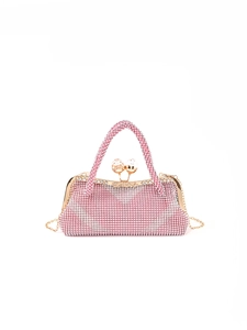 Close-up of pink and silver rhinestones on luxury evening clutch with gold metal clasp